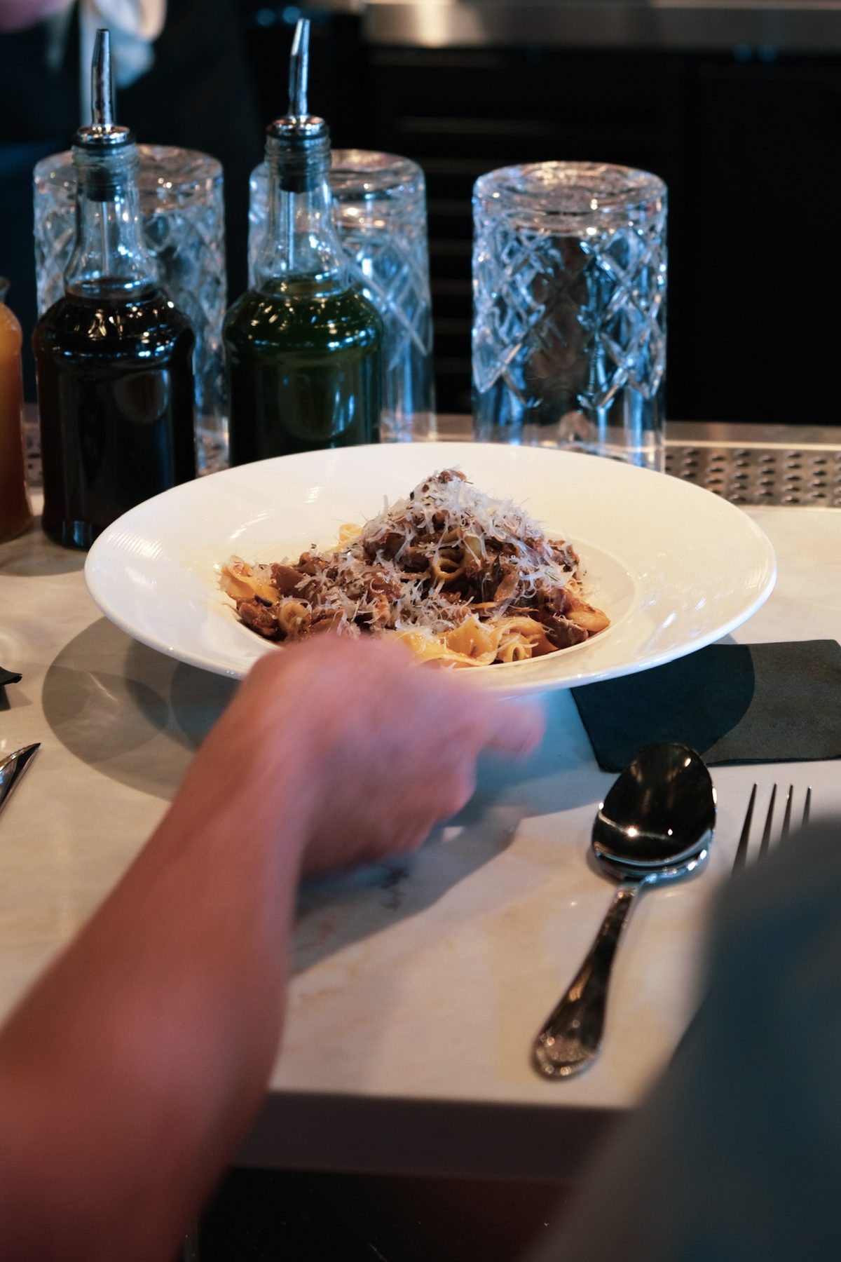 Pappardelle with a slow-braised ragù, finished with grated cheese