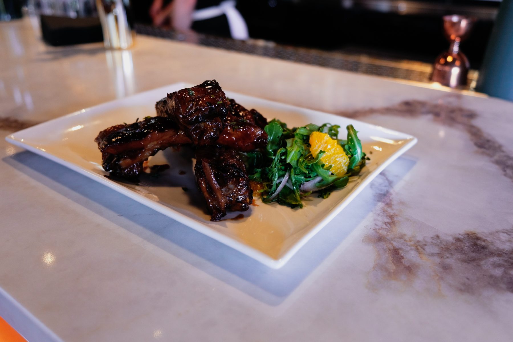 Glazed short ribs with an arugula and citrus salad