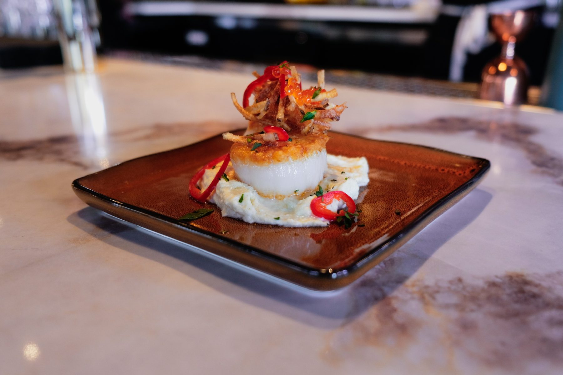 Seared scallop with whipped ricotta and crispy potato at Olive & May